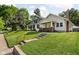 Exterior view of two homes with manicured lawns, mature trees, and inviting curb appeal at 4137 Rookwood Ave, Indianapolis, IN 46208