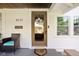 Charming front door with a decorative flower accent, a 'HOME' welcome mat, and porch seating at 4137 Rookwood Ave, Indianapolis, IN 46208