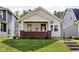Charming bungalow with a brick foundation, inviting front porch, and well-maintained lawn at 4137 Rookwood Ave, Indianapolis, IN 46208