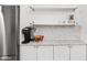 Kitchen featuring white cabinets, open shelving, stainless steel refrigerator, and modern appliances at 4137 Rookwood Ave, Indianapolis, IN 46208