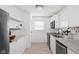 Well-lit kitchen featuring white cabinets, granite countertops, stainless steel appliances, and a modern sink at 4137 Rookwood Ave, Indianapolis, IN 46208