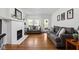 Bright living room with hardwood floors, brick fireplace, and comfortable seating arrangement at 4137 Rookwood Ave, Indianapolis, IN 46208
