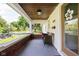 Inviting covered porch with brick accents, comfortable seating, and a view of the neighborhood at 4137 Rookwood Ave, Indianapolis, IN 46208