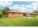 View of the backyard, with a well-maintained lawn, a patio, and a fire pit for entertaining guests at 418 Dunbar Dr, Indianapolis, IN 46229