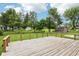 Backyard deck offering a scenic view, surrounded by lush greenery and mature trees, creating an ideal outdoor living space at 418 Dunbar Dr, Indianapolis, IN 46229