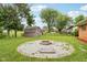 Grassy backyard features a cozy fire pit area, ideal for outdoor gatherings and relaxation at 418 Dunbar Dr, Indianapolis, IN 46229