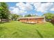 Large backyard features a well-maintained lawn and a patio area, perfect for outdoor activities and entertaining guests at 418 Dunbar Dr, Indianapolis, IN 46229