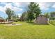 Large backyard with a shed, firepit, and deck, perfect for outdoor activities and entertaining at 418 Dunbar Dr, Indianapolis, IN 46229