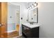 Modern bathroom with wood floors, and dark vanity at 418 Dunbar Dr, Indianapolis, IN 46229