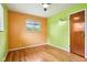 An empty bedroom that features hardwood floors and two windows at 418 Dunbar Dr, Indianapolis, IN 46229