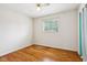Cozy bedroom with hardwood floors, a ceiling fan, and a bright window overlooking the yard at 418 Dunbar Dr, Indianapolis, IN 46229