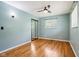 Bright bedroom features wood floors, a ceiling fan, and mirrored closet at 418 Dunbar Dr, Indianapolis, IN 46229