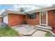 Brick home featuring large windows, a beautiful front door, and a well-maintained lawn at 418 Dunbar Dr, Indianapolis, IN 46229