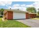 This inviting brick home includes an attached two car garage and well manicured lawn at 418 Dunbar Dr, Indianapolis, IN 46229