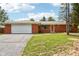 Charming brick ranch-style home featuring an attached two-car garage and a well-maintained front yard at 418 Dunbar Dr, Indianapolis, IN 46229