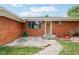 This inviting brick home features a well-maintained lawn, and a beautiful front door at 418 Dunbar Dr, Indianapolis, IN 46229