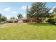 Charming one-story brick home with a well-maintained lawn, mature trees, and a private driveway at 418 Dunbar Dr, Indianapolis, IN 46229