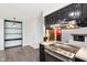 View of the kitchen featuring cooktop and open shelving leading to living room at 418 Dunbar Dr, Indianapolis, IN 46229
