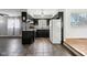 View of kitchen featuring black cabinetry, white appliances, and tile flooring at 418 Dunbar Dr, Indianapolis, IN 46229