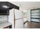 View of refrigerator and counterspace with kitchen leading to bright living room at 418 Dunbar Dr, Indianapolis, IN 46229