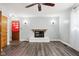 Cozy living room featuring a fireplace, ceiling fan, and wood-look flooring at 418 Dunbar Dr, Indianapolis, IN 46229
