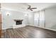 Spacious living room with brick fireplace, vinyl floors, and ceiling fan at 418 Dunbar Dr, Indianapolis, IN 46229