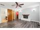 Bright living room with ceiling fan and wood-look floors leading to bathroom at 418 Dunbar Dr, Indianapolis, IN 46229