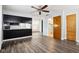 Open concept living space with kitchen bar, wood-look floors and bright lighting at 418 Dunbar Dr, Indianapolis, IN 46229
