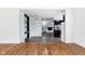 Open-concept living room with hardwood floors, kitchen view, and great natural light at 418 Dunbar Dr, Indianapolis, IN 46229