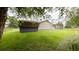 Backyard featuring a storage shed, mature trees and a view of neighboring properties at 430 Heritage Dr, Danville, IN 46122
