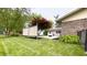 Lush backyard featuring a well-maintained lawn, privacy screen and tidy garden beds at 430 Heritage Dr, Danville, IN 46122