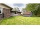 Landscaped backyard featuring a well-maintained lawn, a storage shed and mature trees at 430 Heritage Dr, Danville, IN 46122