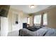 Comfortable bedroom with queen bed, mirror closet door and bright natural light from a large window at 430 Heritage Dr, Danville, IN 46122