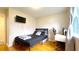 Bedroom with hardwood floors, a black bed, and a flat screen television at 430 Heritage Dr, Danville, IN 46122