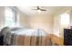 Warm bedroom featuring hardwood flooring, a ceiling fan, and natural light from a window at 430 Heritage Dr, Danville, IN 46122