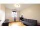 Bedroom with hardwood floors, a grey futon, black desk, and a sunlit window at 430 Heritage Dr, Danville, IN 46122