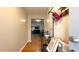 Inviting foyer with hardwood floors, coat rack, and bench; view into adjacent living spaces at 430 Heritage Dr, Danville, IN 46122