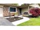 Close-up view of the home's well-landscaped entryway with a walkway, flower bed, and covered porch at 430 Heritage Dr, Danville, IN 46122