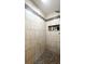 Modern shower with tan and brown tile and mosaic tile floor, featuring a shower shelf at 430 Heritage Dr, Danville, IN 46122
