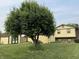 Spacious backyard with large tree, green lawn, storage shed, and partial view of the house at 4928 Dancer Dr, Indianapolis, IN 46237