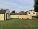 Spacious backyard featuring a storage shed, green lawn, and partial view of the house with a fence at 4928 Dancer Dr, Indianapolis, IN 46237