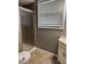 Small, but clean bathroom with a glass shower, window with blinds, and tiled floor at 4928 Dancer Dr, Indianapolis, IN 46237