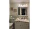 Vintage-style bathroom with green tile, decorative accents, and vanity with sink at 4928 Dancer Dr, Indianapolis, IN 46237