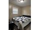 Simple bedroom with window and a neatly made bed with neutral decor at 4928 Dancer Dr, Indianapolis, IN 46237