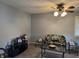 Relaxing living room features neutral paint and furniture, and a unique ceiling fan at 4928 Dancer Dr, Indianapolis, IN 46237