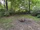 A cozy backyard with a clearing and space for a fire pit at 5010 Melbourne Rd, Indianapolis, IN 46228