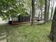 View of a charming backyard featuring a screened-in porch, hammock, and lush green space at 5010 Melbourne Rd, Indianapolis, IN 46228