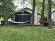 The backyard features mature trees, hammock, screened-in porch and cozy outdoor living at 5010 Melbourne Rd, Indianapolis, IN 46228