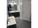 A bathroom showcasing dual sinks, gray hexagon tile floors and storage shelves at 5010 Melbourne Rd, Indianapolis, IN 46228