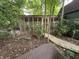 Outdoor view of the chicken coop in the wooded backyard at 5010 Melbourne Rd, Indianapolis, IN 46228